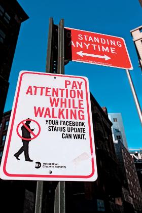 „Zachowaj uwagę podczas spaceru. Aktualizacja statusu na Facebooku może zaczekać” - znak drogowy w Nowym Jorku.
