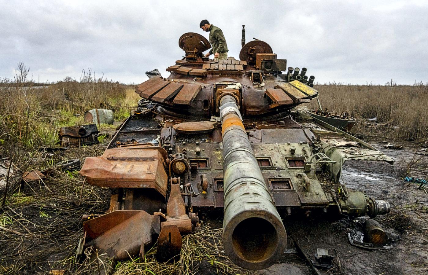 Ukraiński żołnierz dokonuje oględzin rosyjskiego czołgu przejętego pod wsią Kamianka, 30 października 2022 r.