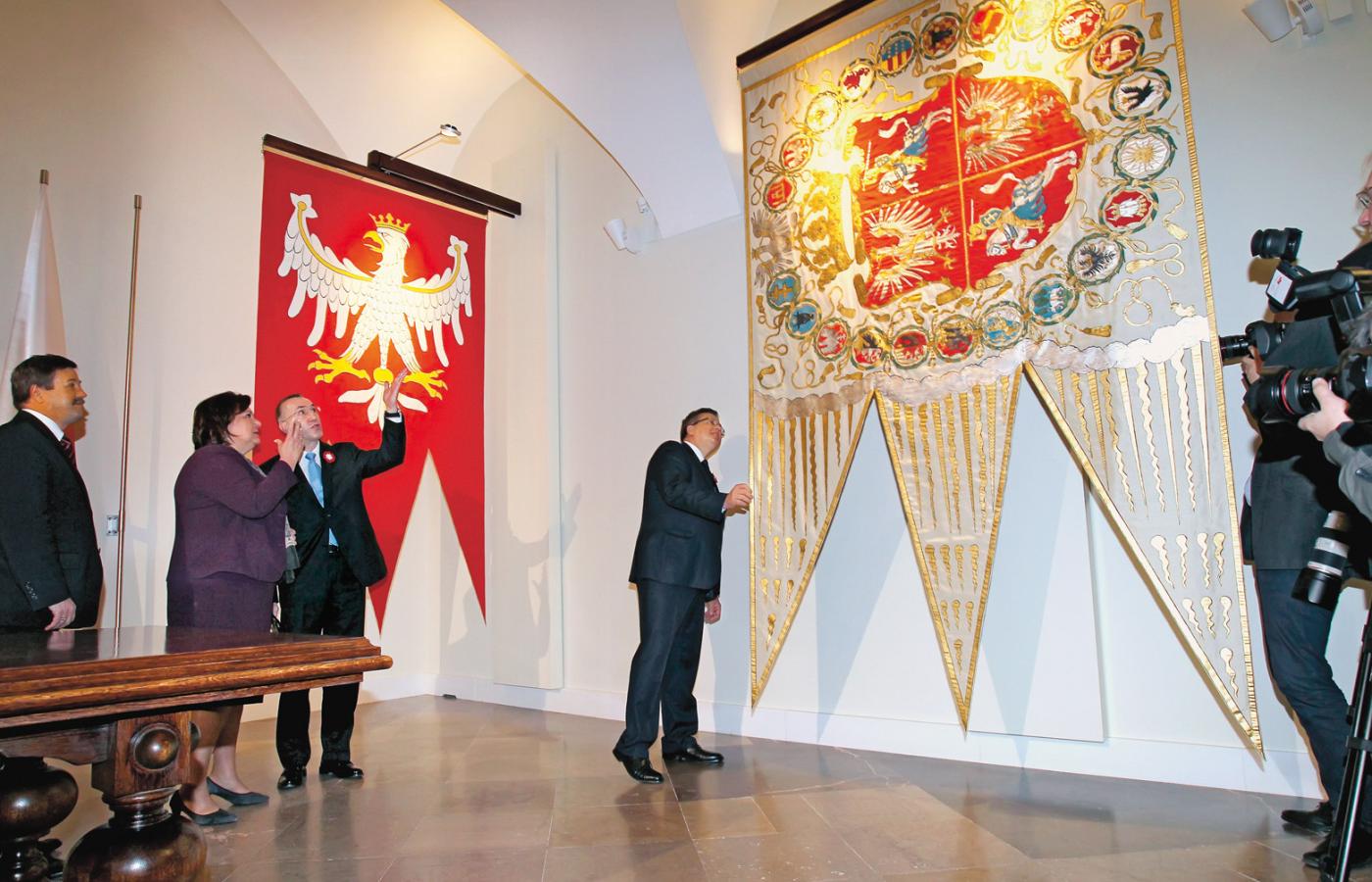 Para prezydencka ogląda repliki Chorągwi Wielkiej Królestwa Polskiego oraz chorągwi Rzeczpospolitej Obojga Narodów.