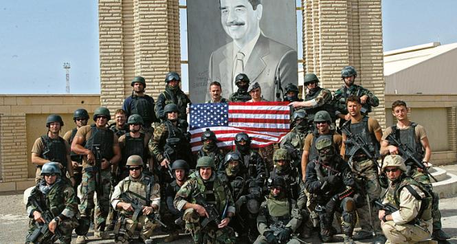 Polskie siły specjalne i US Navy Seals pod portretem irackiego prezydenta Saddama Husajna w Iraku, 2003 r. W środku płk Roman Polko, dowódca GROM w latach 2000–04.