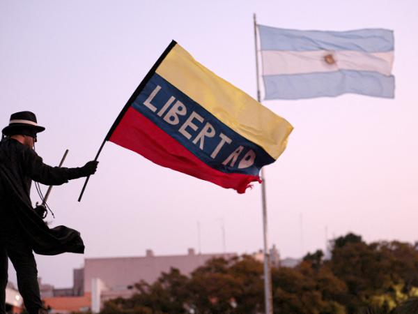 Postać „Zorro” macha wenezuelską flagą podczas protestu przeciwko Nicolasowi Maduro. Buenos Aires, sierpień 2024 r.