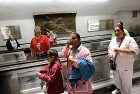 Pielgrzymi oglądają wiadomości o wyborze Franciszka w korytarzu Bazyliki Matki Boskiej z Guadelupe w stolicy Meksyku.