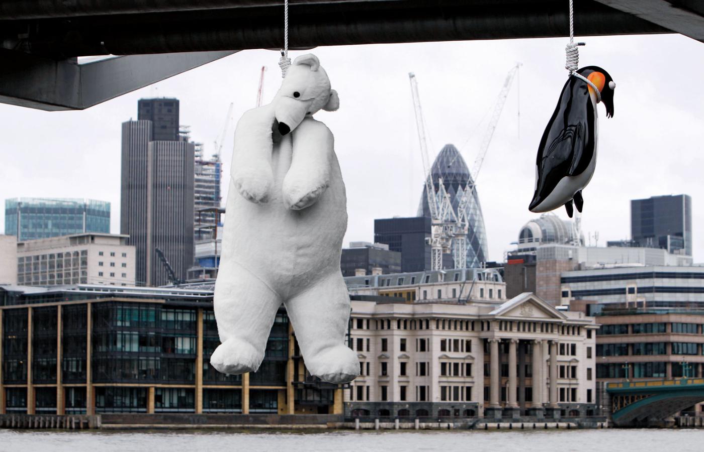 Happening Vincenta Huanga „Samobójstwo pingwinów”. Szklane pingwiny i pluszowy miś polarny powieszone pod mostem Millennium Bridge w Londynie symbolizują grozę zmian klimatycznych.