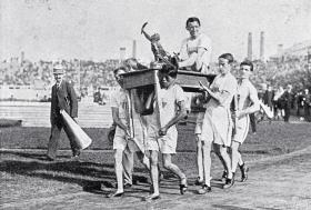 1908 r. Londyn, zwycięzca maratonu John Hayes niesiony przez innych uczestników biegu.