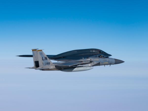 Myśliwiec F-15C Eagle leci obok bombowca Stealth B-2 Spirit nad Morzem Północnym u wybrzeży Szkocji. 25 sierpnia 2021 r.