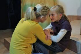 Ania pociesza dziewczynkę, która z trojgiem rodzeństwa trafiła do rodziny zastępczej.